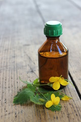 Pharmacy glass bottle and flower celandine