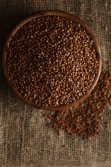 Bowl of buckwheat on sackcloth. Stock image