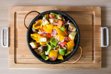 Mixed pepper salad in a wooden tray