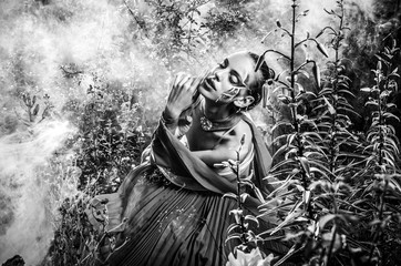 Naklejka premium Attractive romantic woman on beautiful dress pose outdoor. Black-white fine art photo.