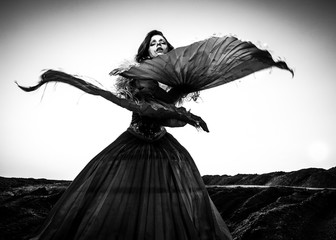 Fototapeta premium Black-white fine art portrait of attractive romantic woman at fairy tale dry field.