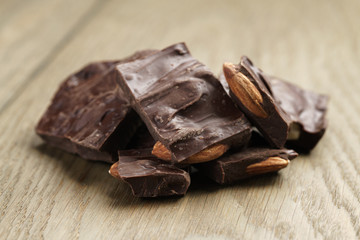 homemade chocolate with almond nuts on oak wood table, shallow focus