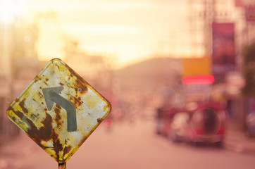 Traffic sign,old curve road sign on blur traffic road