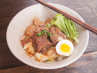 hot and spicy instant noodle on wooden table