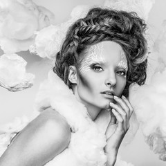 Naklejka premium Romantic beauty with magnificent hair wandering in clouds. Fine art black-white studio fashion portrait.