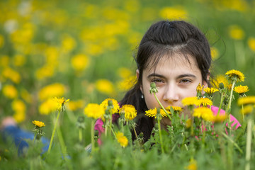 Portrait of a teenage girl lying in the grass.