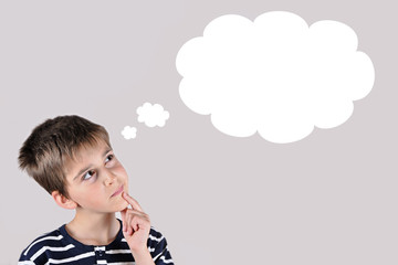 Thoughtful young boy with an empty thought bubble