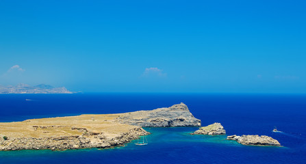 Sea Island rocks and ships Rhodes Greece sunny day
