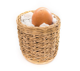 Single Egg with little bit crack in handicraft basket on white background.