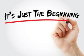 Hand writing It's Just The Beginning with marker, business concept background