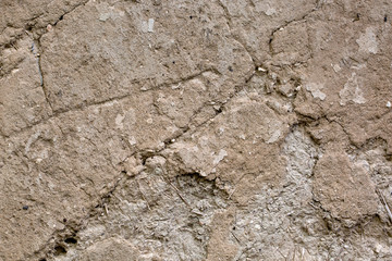 Cracked beige clay wall . Background. Texture