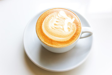 Close up cappuccino coffee on table with bird face