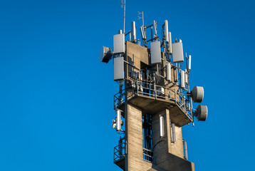 Communications equipment mounted atop a high concrete tower.
