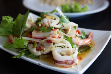 Thai spicy salad pork and seafood mix vegetable.