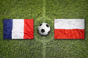 France vs. Poland flags on soccer field © BirgitKorber