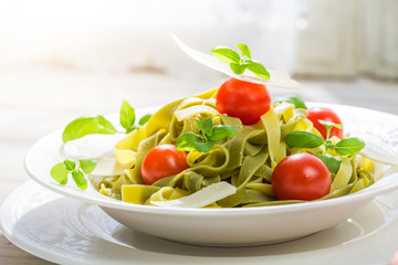 Closeup of tasty tagliatelle with tomatoes and parmesan