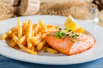 Closeup of homemade french fries and salmon