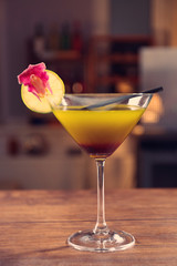 Glass of cocktail on bar background