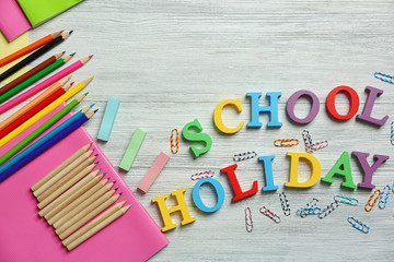 Set of stationery with alphabet on white wooden table
