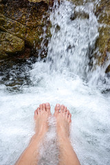 rest relaxing foot in waterfall in tropical forest