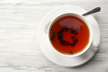 Cup of tea on white table, top view