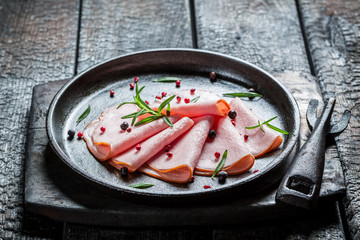 Smoked cold meats with pepper and spices on buried board