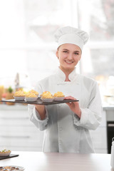 Female chef working at kitchen