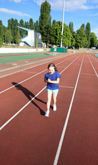 Obraz premium Little girl have fun on the stadium
