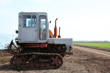 Fototapeta na wymiar Grey tractor at farm