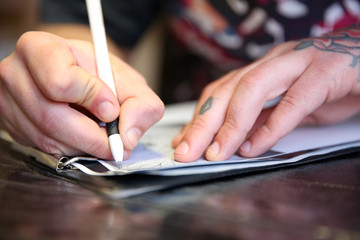Male hand painting picture in notebook