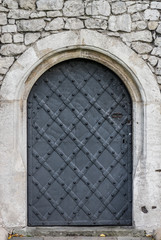 Old iron door reinforced with steel belts