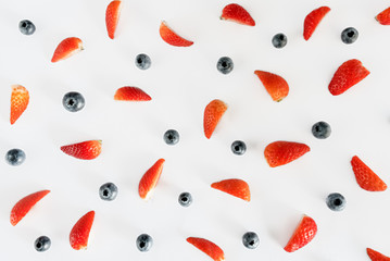strawberries and blueberries on white background. Flat lay. Top view.