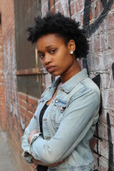 Close-up of a sad and depressed African woman deep in thought outdoors.