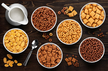Collection of breakfast cereal on a wooden background. Cornflake