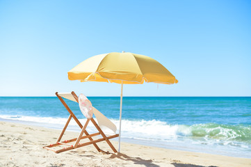 Female hat, chair and umbrella on stunning tropical beach background vacation 