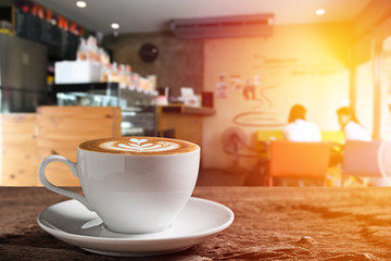 white coffee cup on wooden table with coffee bar background