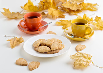 Autumn. Two cups of coffee and cookies in the shape of the leave