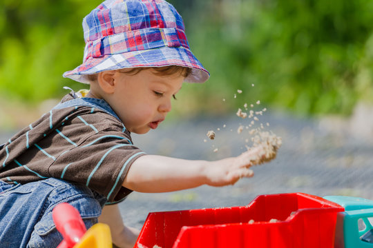 Baby Plays In Sandbox