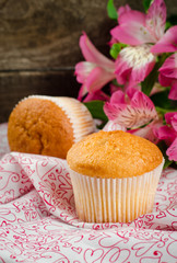 Freshly baked cupcakes on wooden background. Selective focus