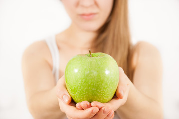 A young beautiful woman with a green apple