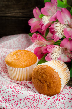 Freshly baked cupcakes on wooden background. Selective focus