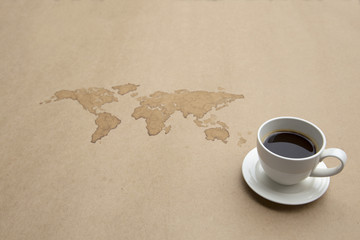 Coffee painted of Earth map on paper with a cup of coffee