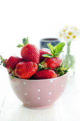 Bowl with strawberry, still life backlight photography