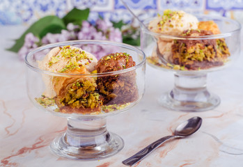Baklava with ice cream on marble background.  Turkish arabic cuisine. Ramadan food. Selective focus