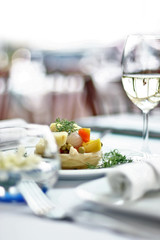 Artichoke and white wine on the dinner table.