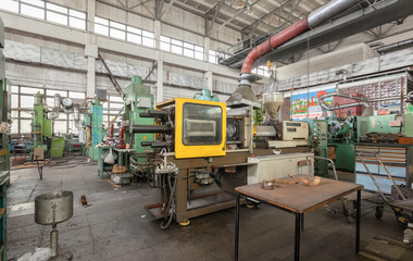 Machinery plant. Workshop for production of thermoplastic parts. Injection molding plastic machine