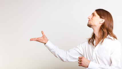 Fototapeta premium Young man making catching gesture.