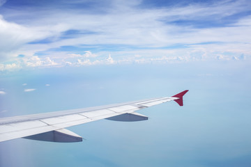 Fototapeta premium Above the clouds.Wing aircraft in the sky under earth of Bali,Indonesia