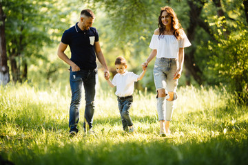 Fototapeta premium Happy family running in the park