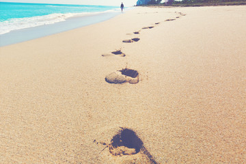 Footprints in the sand of a tropical beach